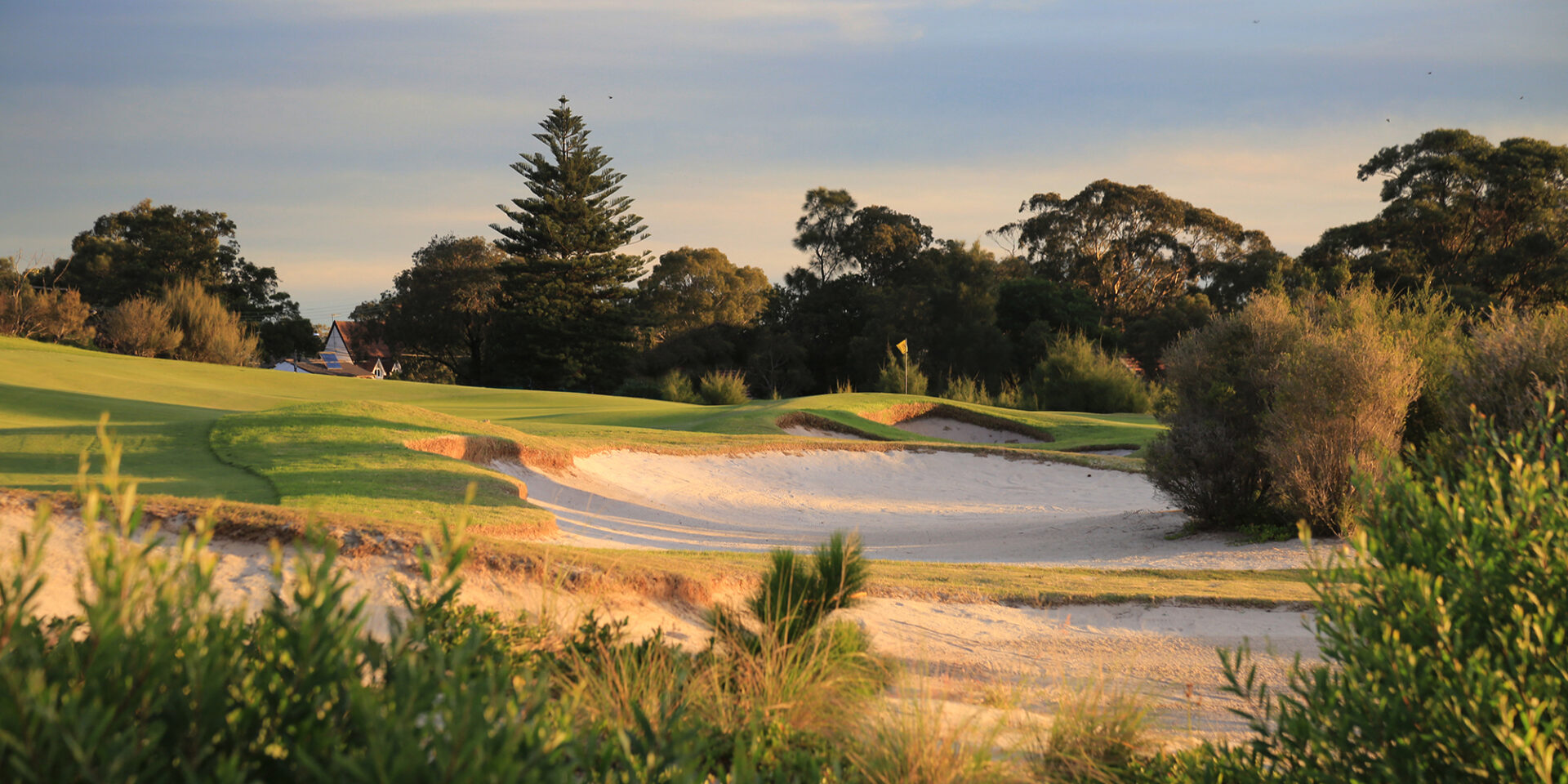 Sculpted sand bunker guarding a green at Bonnie Doon Golf Club